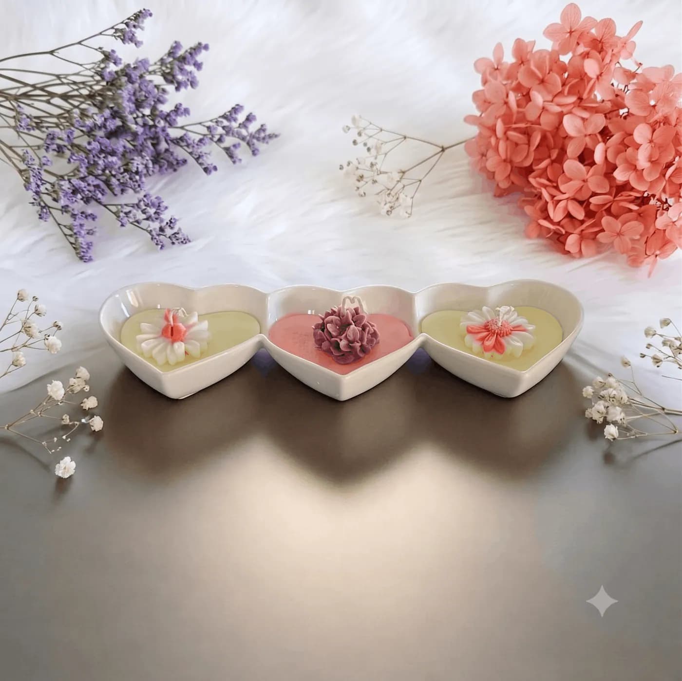 Three petite heart-shaped floral candles