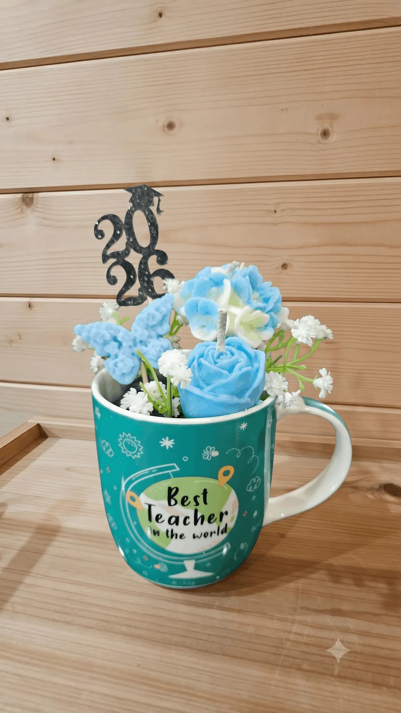 Blue floral candle arrangement in a teacher gift mug