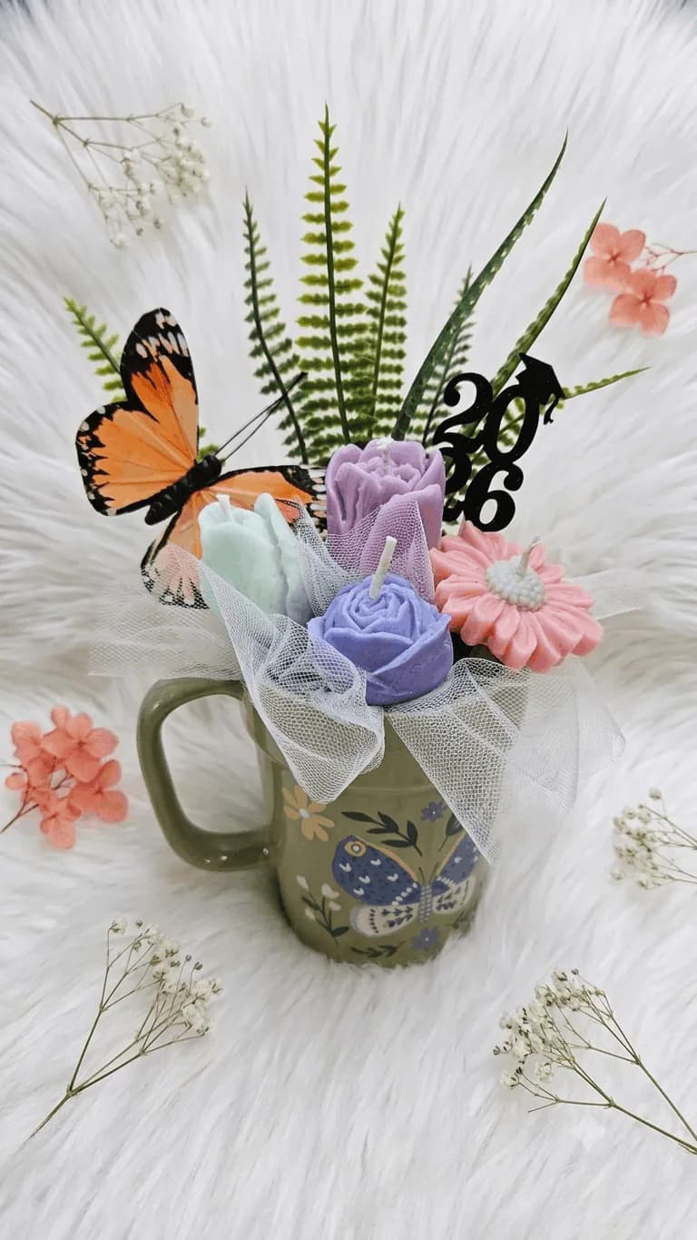 Pastel floral candle arrangement with a butterfly detail