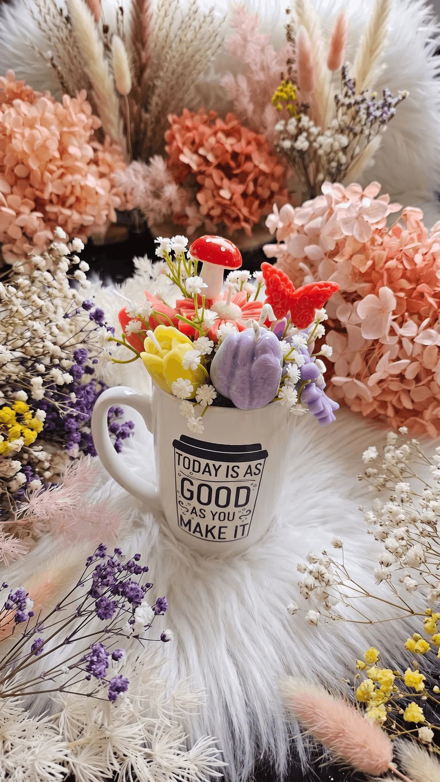 Colourful floral candle arrangement in a keepsake mug