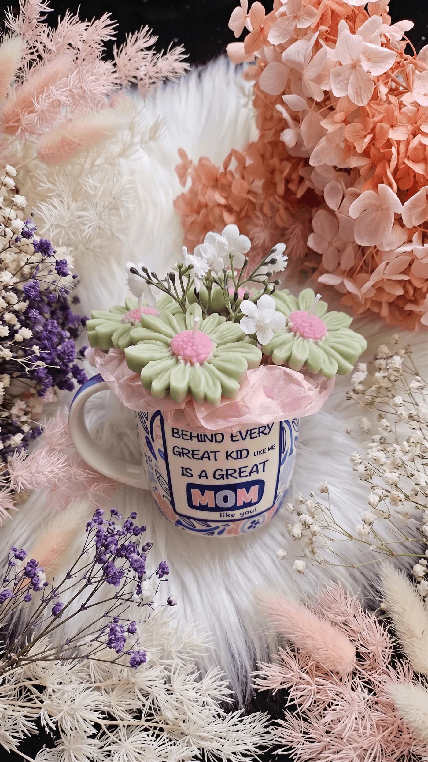 Pastel daisy candle arrangement in a message mug