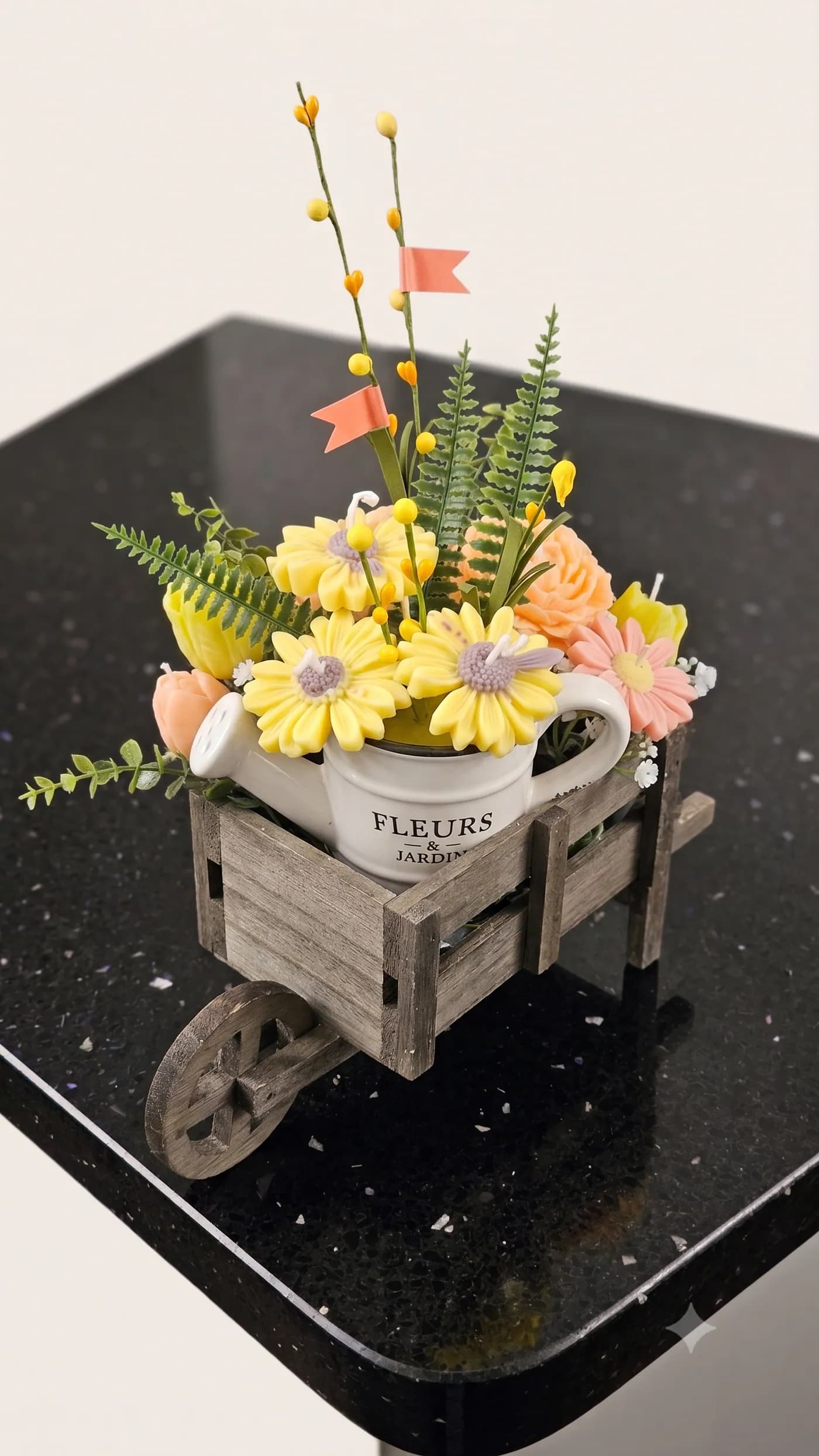 Yellow floral candle garden in a rustic wooden cart