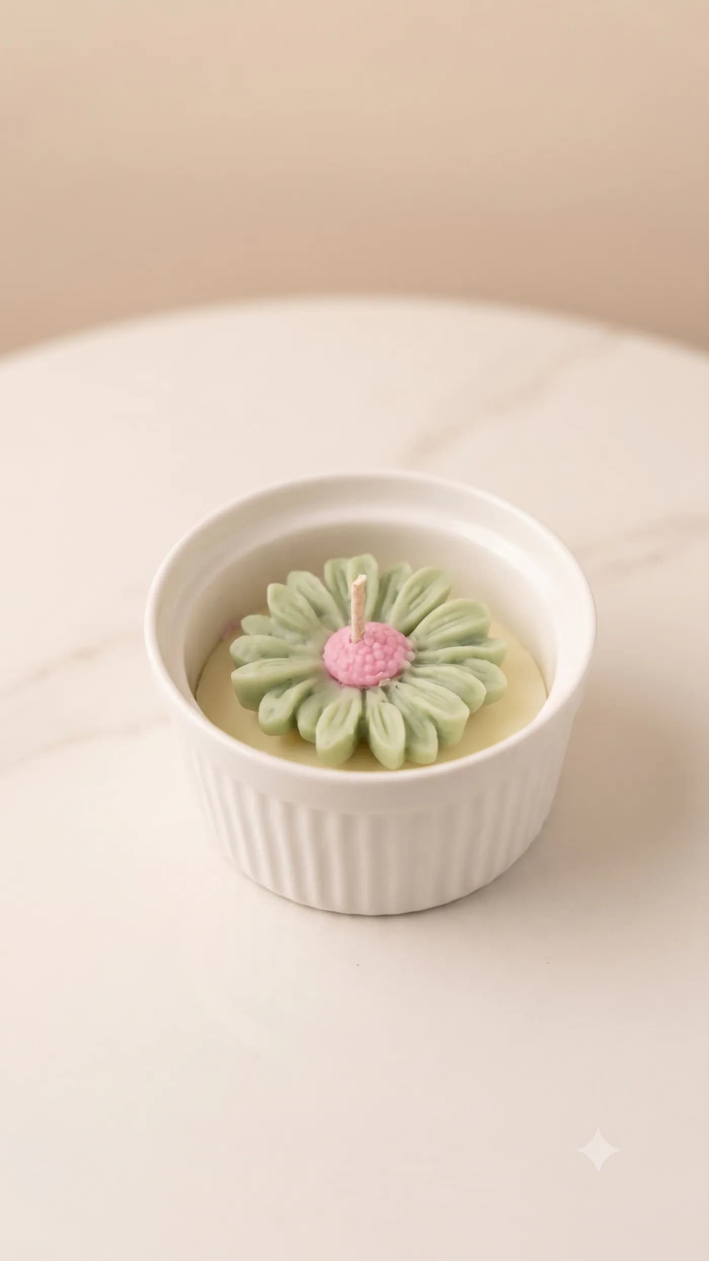 Petite white ceramic candle topped with a pastel daisy
