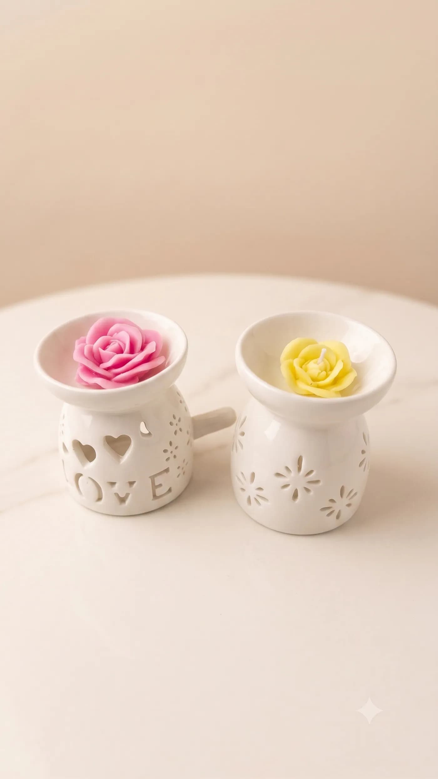 Pink and yellow rose candles in white ceramic warmers