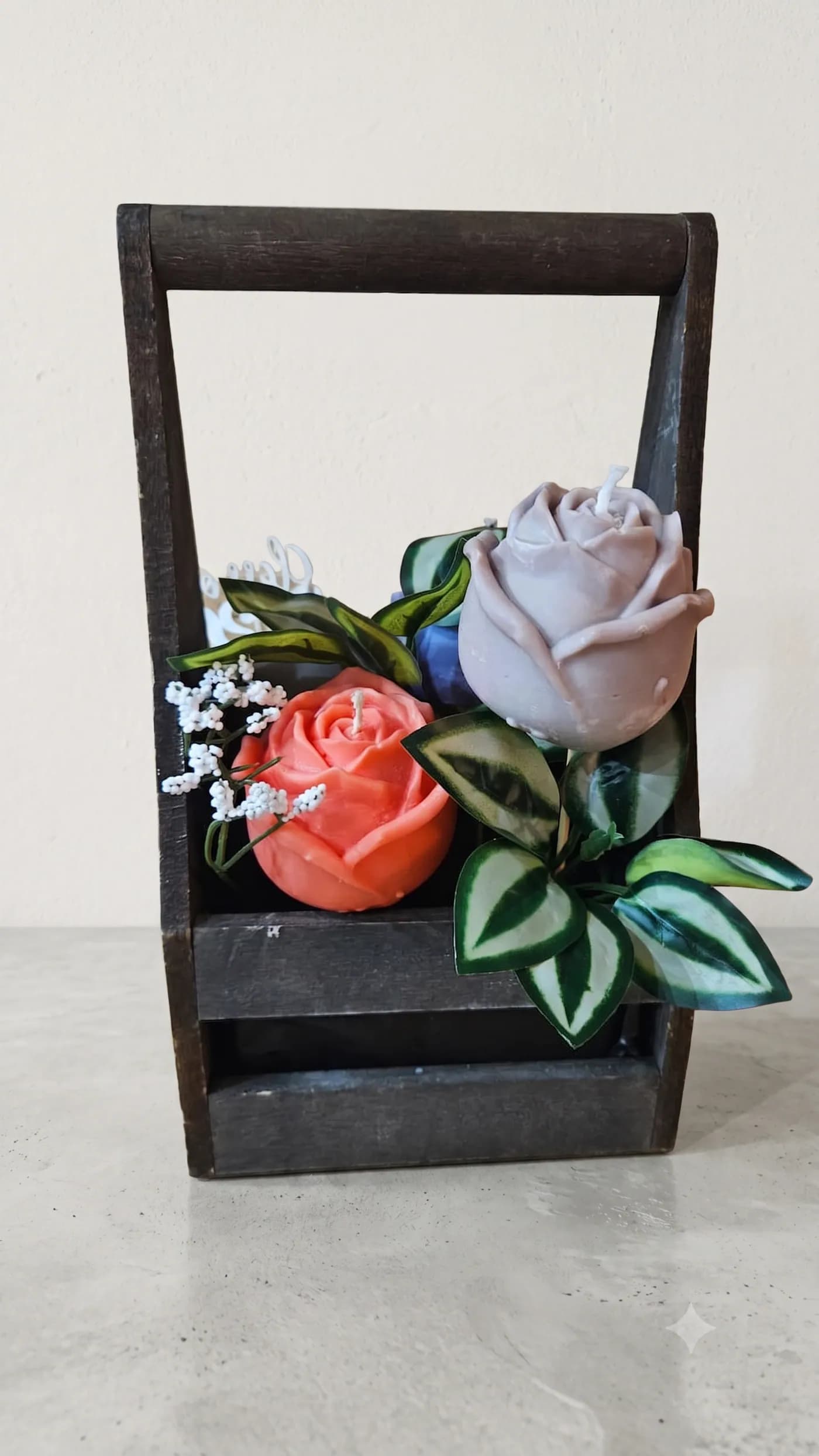Rose candle arrangement in a dark wooden keepsake
