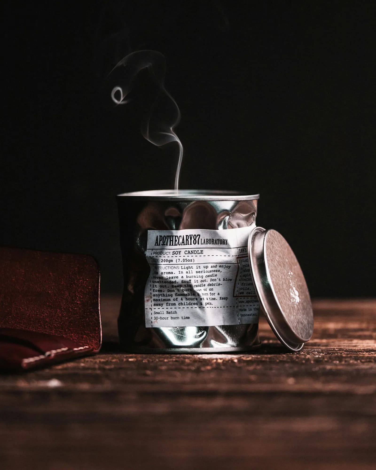 A recently extinguished candle with a delicate trail of smoke