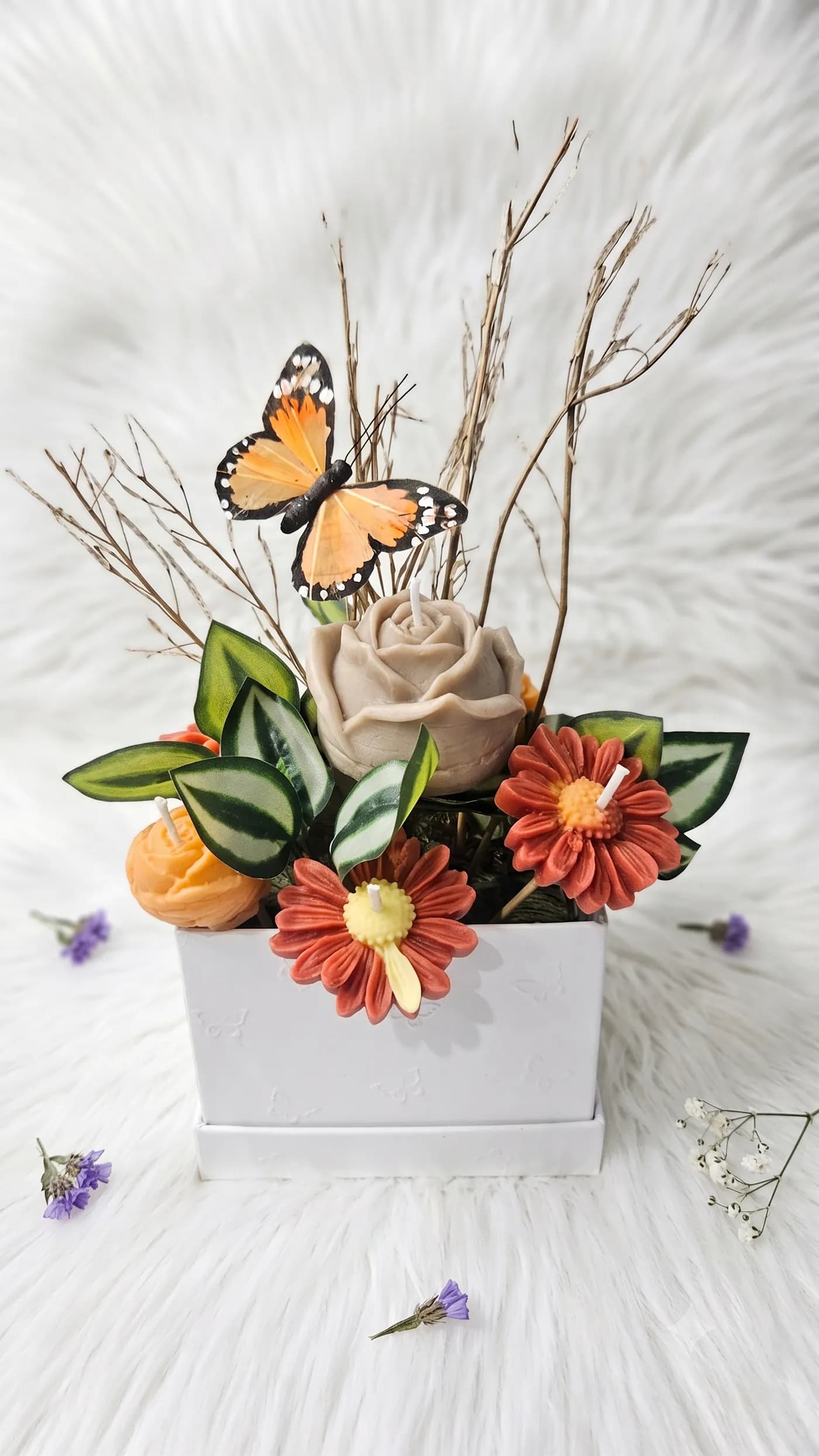 Butterfly and rose candle arrangement in a white planter